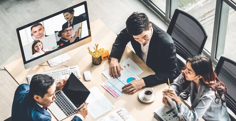 people at the desk with a zoom call building collaborative and efficient remote teams