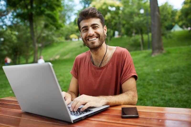 remote-worker-freelancer-working-remote-sit-park-bench-with-laptop-connect-wifi